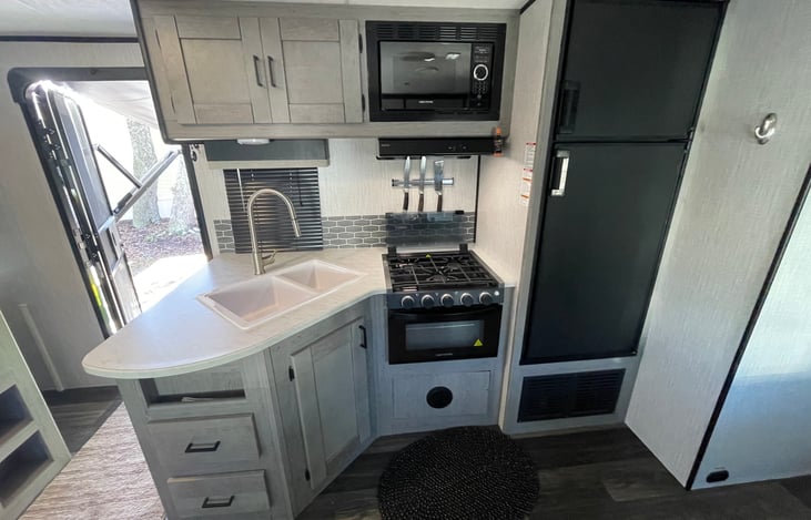 3 burner stove, oven, microwave and oversized fridge/freezer