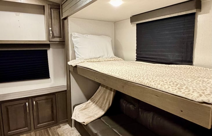 Top bunk bed folds down for extra sleeping