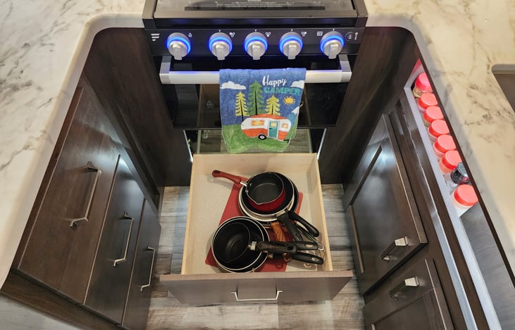 Pots and pans under the oven.
