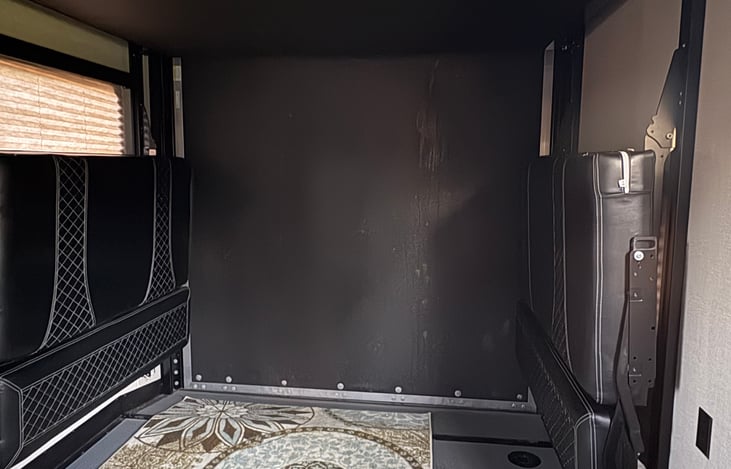 Toy hauler converts to another living room/bunks.