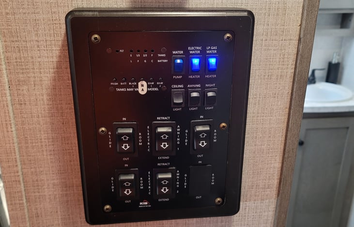 Panel with tankless water heater and electric water heater.