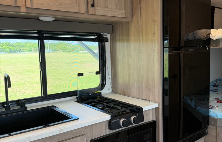 Your home kitchen on wheels, complete with a complimentary coffee maker, cookware, and utensils.