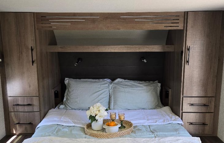 queen bed with his and hers closets chargers also located near head board