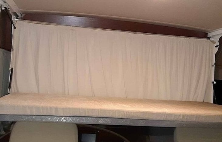 Flip down bed over the drivers / passenger seat