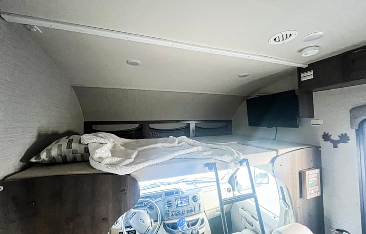 Bunk over cab with ladder access, tv that extends out to living area