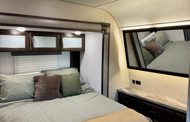 The bedroom comes complete with a large mirror, and ample storage for your personal belongings during your stay.