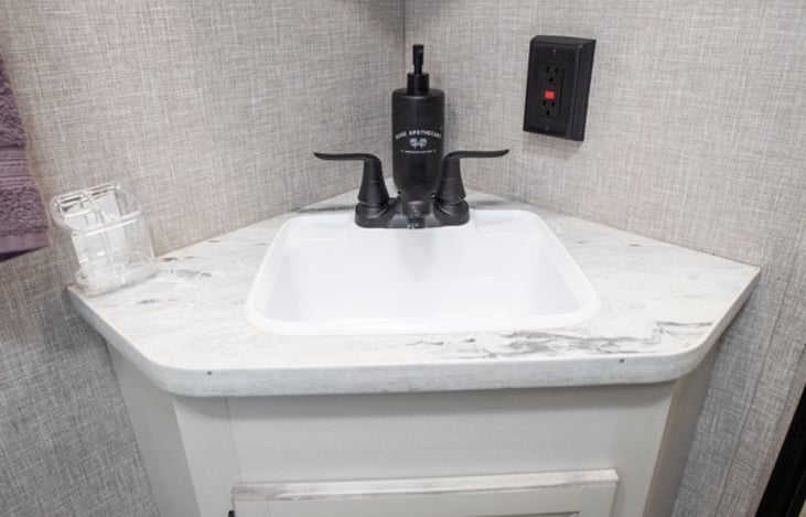 Bathroom Sink With Soap Dispenser and Toothbrush Holder