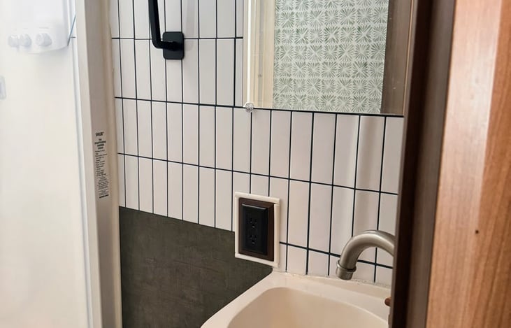 deep sink, mirror, towel hooks and an outlet complete the bathroom! It's tight in there, but totally functional!