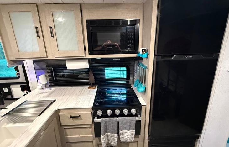 Kitchen with 3-burner stove, oven and microwave
