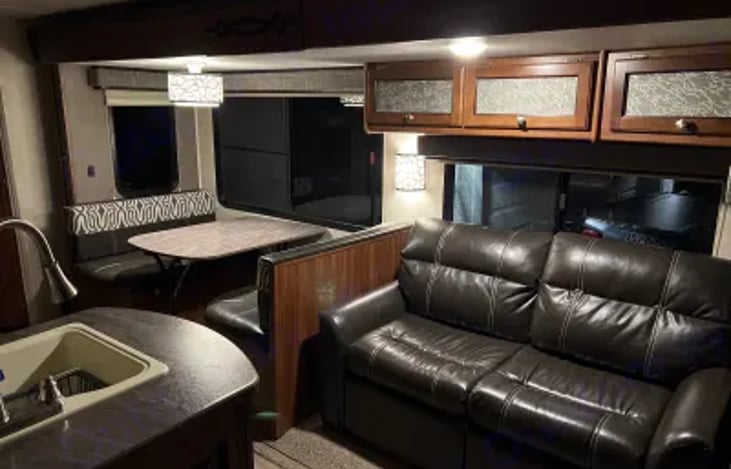 A nice leather couch equipped with a pull-out bed.  The dining table also converts into a bed.