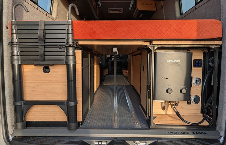 Electric on left, 35 gallon water and hot shower on the right.  Underbed storage.