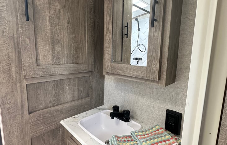 Large vanity mirror with medicine cabinet and extra storage--peek inside to find complimentary toiletries, washcloths and a hairdryer!