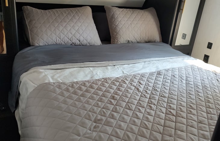 Plush queen mattress for the master bedroom with 32" TV