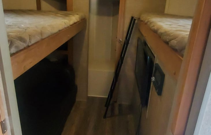 Bunk room, two single beds, and couch below folds out for two people.