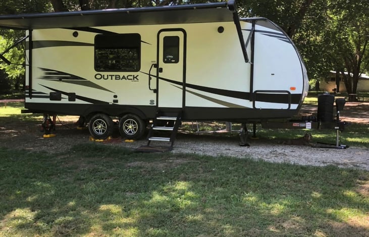 automatic awning and adjustable stairs help when setting up at your camp spot