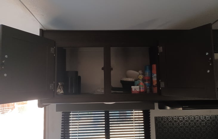 Plenty of cupboard space above kitchen sink.