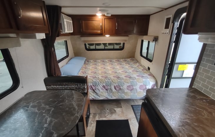 Queen bed with three windows, storage underneath. Privacy curtain can cover the whole bed.