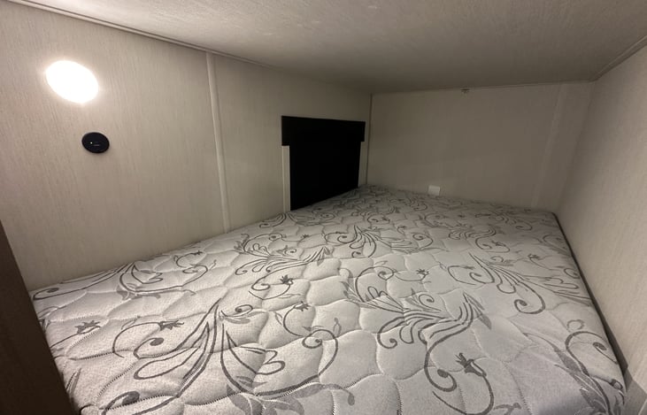 Additional interior detail showing clean walls, lighting, and sleeping space.