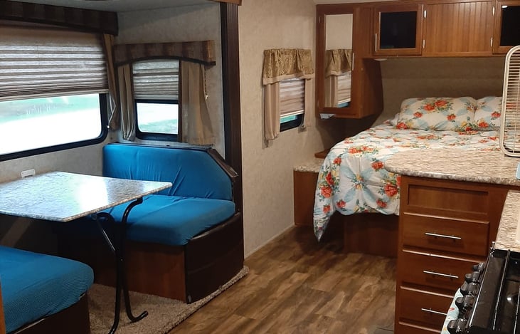 Inside RV you will find sleeping quarters, fully furnished with 1 Queen bed and 1 fold down table bed.