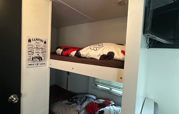 Two twin size bunk beds with new foam mattress on top of bedding.