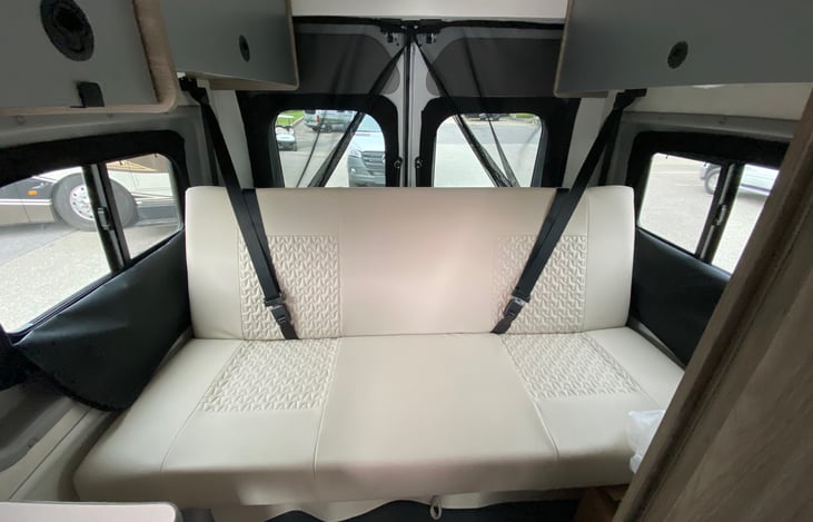 Rear sofa bed has an additional 2 seat belts and converts into a roughly short rv queen bed for 2
