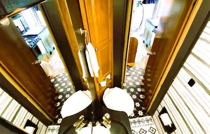 Private RV shower with full-size doors — enjoy comfort and convenience in your motorhome rental.