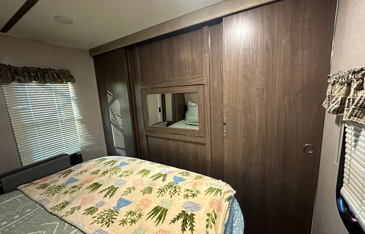 Master bedroom with queen size bed & privacy door closed.
