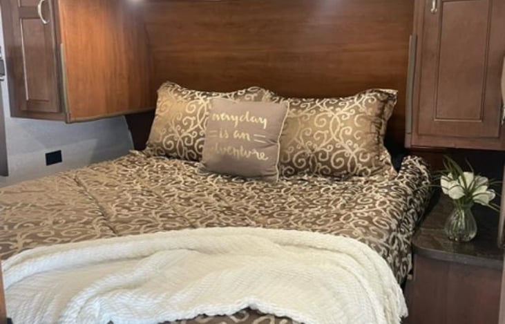 Comfortable queen size bed with bedding