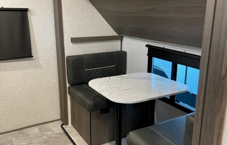 Table for cards or hanging out, or, can go down to make another bunk.  Above is also a drop down bunk, to make 4