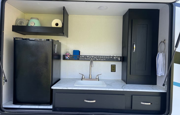 Outdoor kitchen with mini fridge and blender