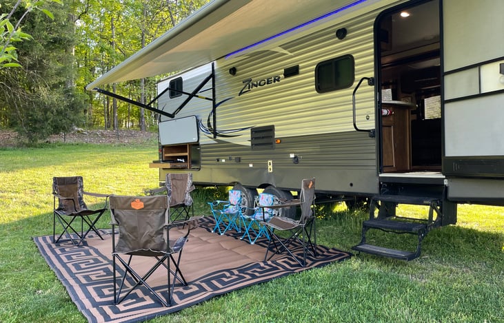 9 x 12 putdoor area rug with 4 Adult and 2 children camping chairs and 2 end tables