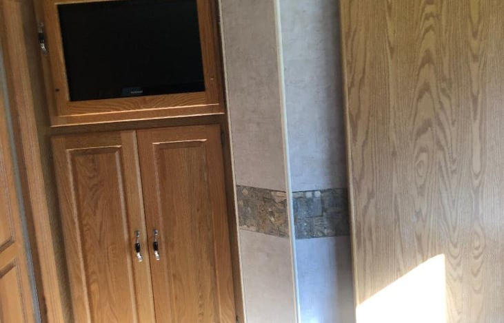 TV. the door swings out for viewing from bed.