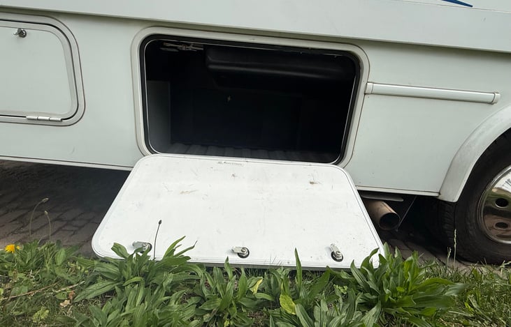 Passenger side compartment - we store firewood in here when we go camping permitting state laws that allow it.