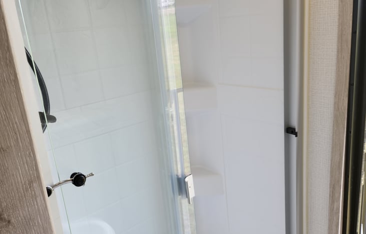 Back suite bathroom shower that has its own entrance.