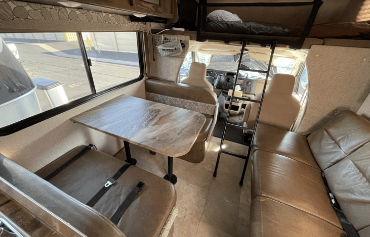 Seats 9 with seatbelts. The living area is spacious and clean.