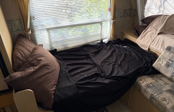 Table turned into a twin bed with bedding