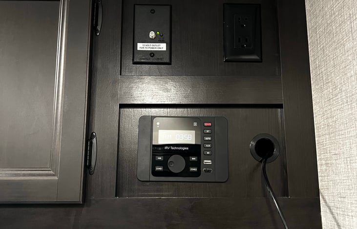 Radio system with speakers inside and out, outlets, and tv hookups.