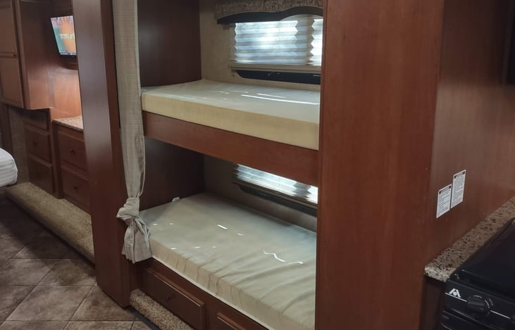 twin bunks between kitchen and bedroom, opposite bathroom