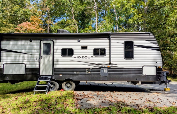 This spacious 2021 Keystone Hideout 250BH sleeps 8 with a bunkhouse layout, outdoor kitchen, and upscale interior. Features include: electric fireplace, central vacuum, outdoor kitchen, and more.