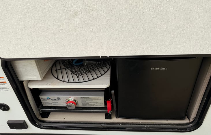 Outdoor kitchen with flat top griddle and mini fridge