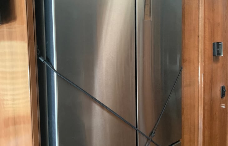 Double door refrigerator with two freezer drawers.
Tons of space and with convertor runs as you drive.