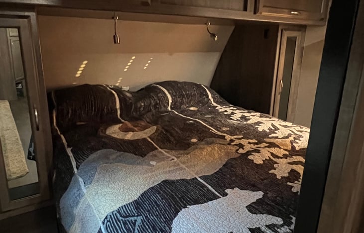 Beautyrest Black Signature Pillow Top Queen Mattress in the master bedroom. Sliding doors offer privacy to the rest of the camper.
