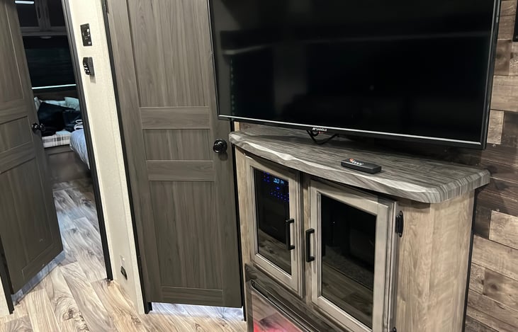 Spacious entertainment cabinet with electric fireplace.