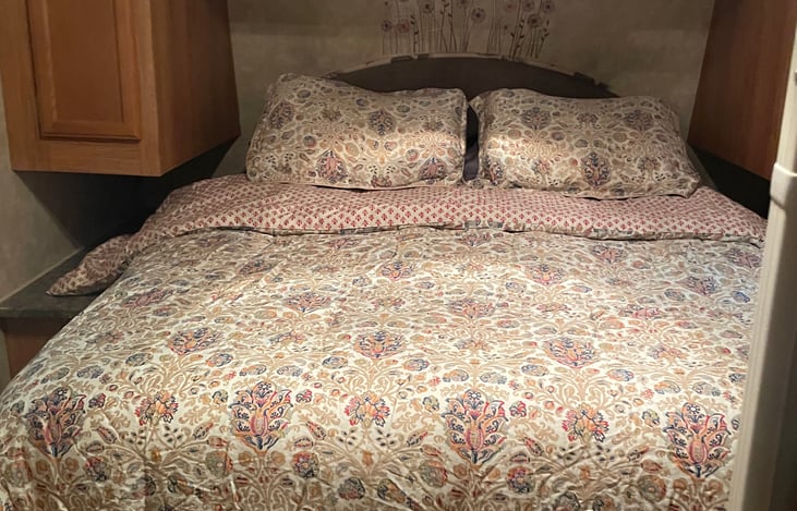 Bedroom features a queen pillow top mattress with Ralph Lauren pillows and bedding. No need to give up luxury at the campsite.