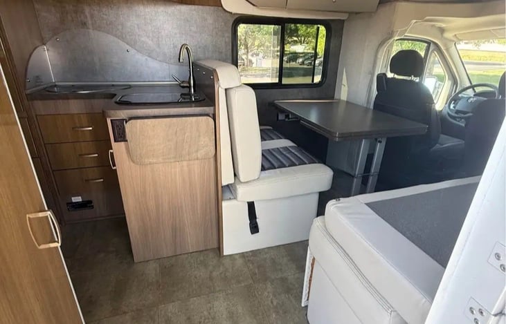 4 seats in the rear all with seat belts. Kitchen table turns into a bed