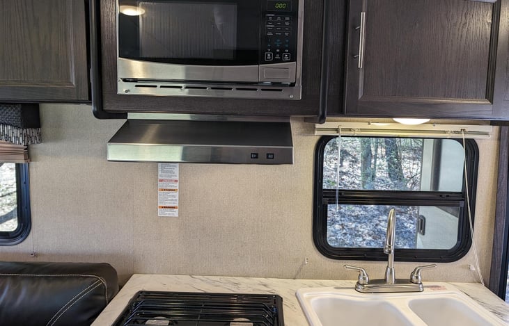 kitchen sink, stove/oven, and microwave.