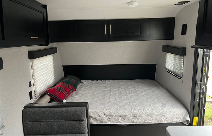 Queen size bed with storage underneath and cabinet overhead