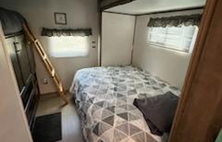 Rear Full size bed. This one if you fold it up, there is an office desk underneath it that folds out.