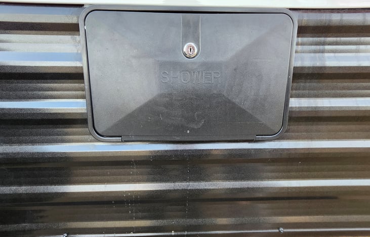 Outside shower with Hot and Cold Water. Small shower enclosure is also included.