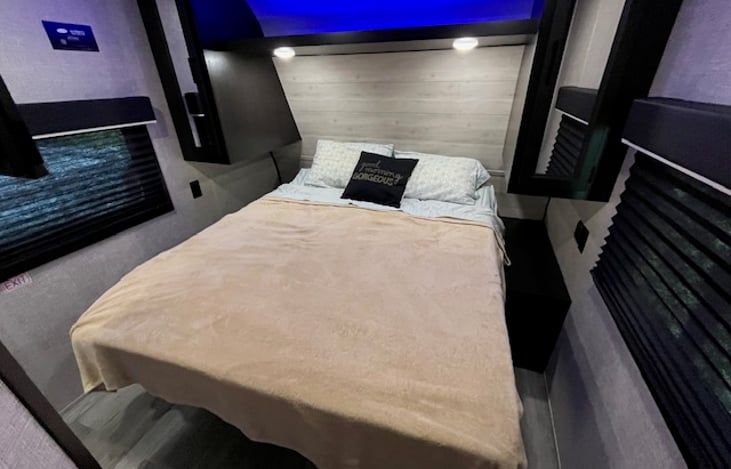 Master private bedroom with blue LED lighting and storage areas on either side of the bed.
